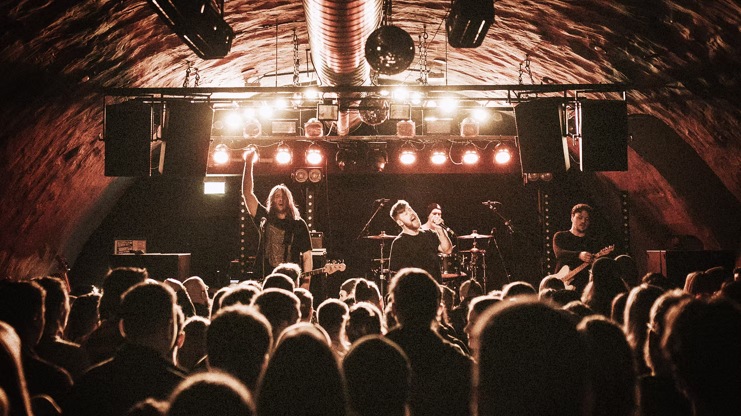 Indie rock concert crowd and stage lights representing the best indie rock songs of all time