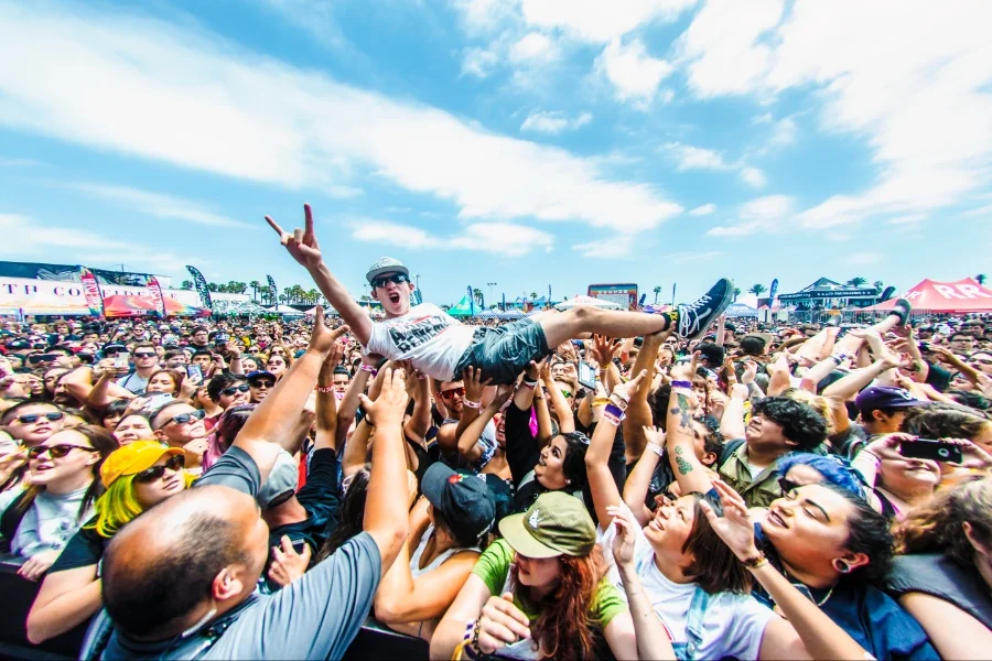 Pop punk concert crowd and stage lights representing the best pop punk songs of all time